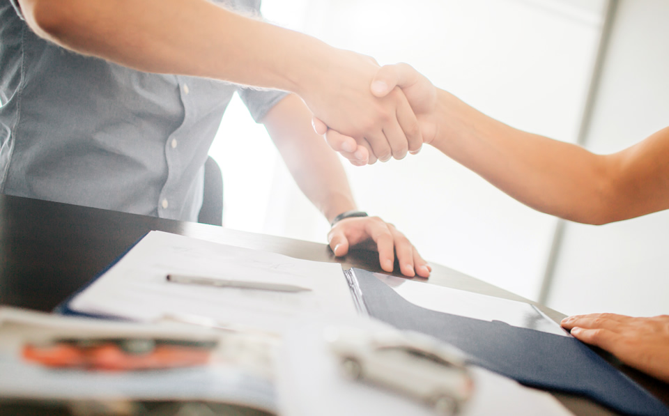 People shaking hands over a contract